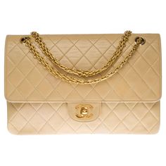 Splendid Chanel Timeless/Classique handbag with double flap in beige quilted lambskin, hardware in gold metal, one Mademoiselle chain strap in gold metal allowing the bag to be worn in the hand or on the shoulder One patch pocket on the back of the bag Lining in beige leather, one double patch pocket, a lipstick loop Signature: "Chanel Paris®Made in France" Date: Before 1986 and the appearance of the hologram Dimensions: 26*18*7cm (10.23*7.08*2.75in.) Chain length: 41 cm (16.14 In.) Reference: 1 Lipstick Liner, Shoulder Support, Flap Shoulder Bag, Classic Handbags, Chanel Paris, Timeless Classic, Metal Chain, Fashion Handbags, Chain Strap