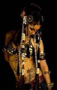 a woman with tattoos and chains on her body