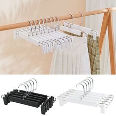 the clothes hanger is hanging on a rail and four pairs of pants hangers are below it