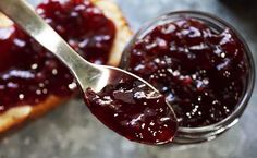 spoon full of jam sitting on top of bread