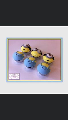 three minion cupcakes sitting on top of each other in blue and yellow