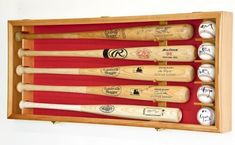 a wooden case holds six baseball bats and balls