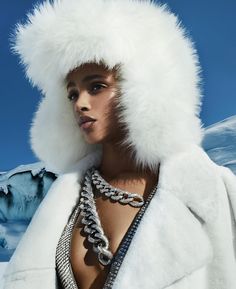 a woman wearing a white fur hat and chains