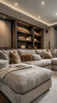 a living room filled with lots of couches and pillows on top of a rug