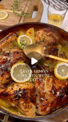 a pan filled with chicken and lemons on top of a table