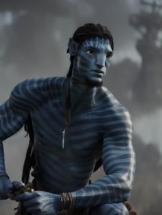 a man with blue paint on his face and body sitting in front of a ship