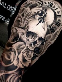 a man's arm with a skull and roses tattoo on it, next to a clock