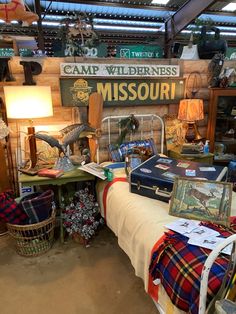 a room filled with lots of different items and decor on display in front of a sign