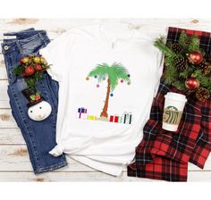 a t - shirt with a palm tree on it next to plaid pants and christmas decorations