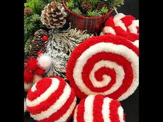 some red and white lollipops are next to pine cones