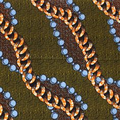 an abstract pattern with orange and blue circles in the center on a brown, black background