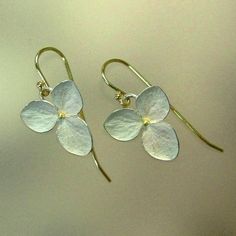 "This is my medium sized three petal hydrangea flower. Made of sterling silver with 18k yellow gold centers and 18k yellow gold earwires. The highly detailed flowers measure 5/8\" (14mm) and are finished with a whitened finish. The edges and fine veins are burnished for a little silvery sparkle. The earrings are finished with solid 18k yellow gold earwires on loops, to give these earrings a bit of movement. Each earring is signed P.Irla, 18k, .925, and copyright. Made to order in 7 to 10 busines Botanical Earrings, Jewelry Advice, Botanical Jewelry, Sterling Silver Flowers, Contemporary Jewellery, Contemporary Jewelry, Stylish Jewelry, Silver Flowers, Earrings Sterling Silver