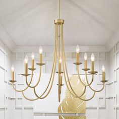 a gold chandelier hangs from the ceiling in a room with white tile walls