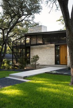 the modern house is surrounded by trees and grass