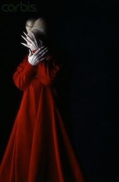 a person in a red dress with their hands on his face and the words corbis above them