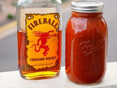 there is a jar of fireball cinnamon whiskey next to a bottle of hot sauce