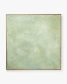 an empty square frame hanging on the wall with a light green paint textured background