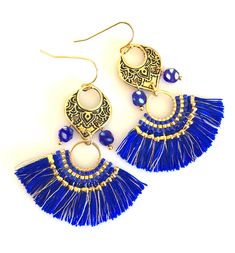 French blue woven tassel earrings with antique gold Moroccan style accents and Czech glass beads. Fun lightweight tassels are woven in rich French blue and gold with authentic Miyuki seed beads. Fans are 59 x 30mm. They hang from antique gold pewter Moroccan chandeliers with little iridescent blue and pearlescent Czech glass beads. Earrings are on gold plated French hooks. Total length is 2 1/2 inch. Very lightweight ! Moroccan Chandeliers, Paris Charm Bracelet, Blue Statement Earrings, Moroccan Chandelier, Blue Tassel Earrings, Style Marocain, Blue Drop Earrings, Dainty Gold Bracelet, Long Tassel Earrings