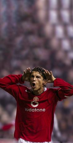 a soccer player holding his hands to his head