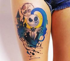 a woman's thigh with a tattoo on it that has a skeleton in the middle