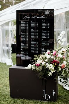 a table with flowers and seating cards on it