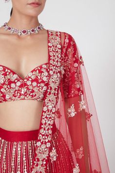 Red blouse with all-over heavy floral embroidery and plunging sweetheart neckline. Comes with lehenga and dupatta.
Component: 3
Embroidered
Neckline: Sweetheart
Sleeve Length: Full
Fabric: Dupion, Net
Color: Red
Tie-up at the back with tassels
Embroidered lehenga
Embellished dupatta
Closure: 
Blouse: Concealed zip closure at the side - Aza Fashions Elegant Red Lehenga For Ceremony, Red Sharara With Floral Embroidery For Wedding, Elegant Red Lehenga With Floral Embroidery, Red Floral Embroidered Sharara For Party, Fitted Red Choli With Floral Embroidery, Red Embroidered Lehenga For Ceremony, Festive Red Choli With Floral Embroidery, Red Floral Embroidered Choli For Festive Occasions, Festive Red Set With Floral Embroidery