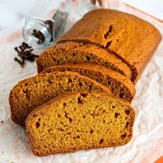 sliced loaf of pumpkin bread on wax paper