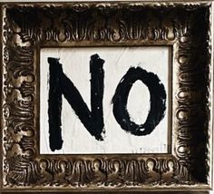 a sign that says no in black and white on a gold framed frame with an ornate pattern