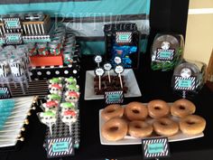 a table topped with lots of donuts and desserts