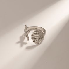 Embrace the spirit of summer with our Adjustable Stainless Steel Bohemian Beach Ring. Crafted to capture the essence of beachside freedom and boho chic, this ring features a unique, irregular design adorned with starfish and shell motifs. Perfect for beach parties, vacations, or just adding a touch of seaside magic to your everyday wear, this ring brings the ocean’s charm right to your fingertips. Product Features The Bohemian Beach Ring is designed with versatility and durability in mind. Its a Wedding Ban, Beach Rings, Wedding Band Styles, Men Shoes Formal, Beach Parties, Bohemian Beach, Steel Design, The Bohemian, Mens Slippers