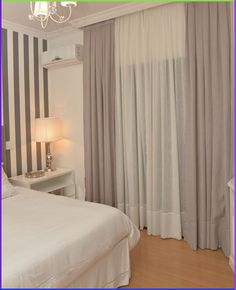 a bedroom with black and white striped walls