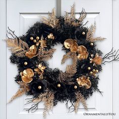 a wreath with black and gold decorations on it