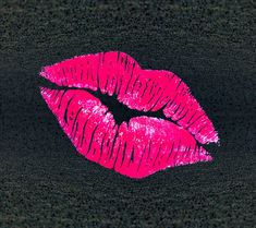 a pink lipstick painted on the side of a black surface