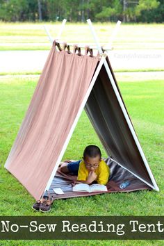 a little boy laying in a tent reading a book with the words no sew reading tent