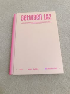 a pink book sitting on top of a white floor