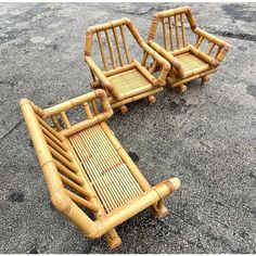 two chairs made out of bamboo sitting on the ground