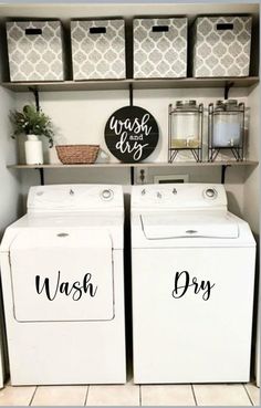 a washer and dryer sitting in a room next to some shelves with baskets on them