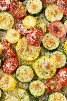 a pizza with zucchini, tomatoes and parmesan cheese is shown here