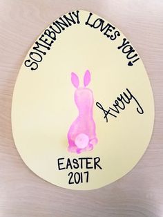 an easter egg with a bunny painted on it and the words, somebody loves you