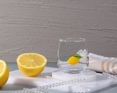 two lemons and a glass on a table