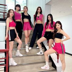 the girls are posing on the stairs in their pink tops and black shorts with white sneakers