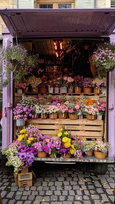 a purple truck filled with lots of flowers