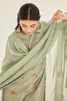 Basil green silk chanderi kurta with placement floral hand block print and checkered zardozi embroidered yoke. Paired with trousers and organza printed dupatta.
Components: 3
Pattern: Printed and Embroidered
Type Of Work: Floral Hand Block Print and Zardozi Work
Neckline: Round Neck
Sleeve Type: Full Sleeves
Fabric: Silk Chanderi, Organza
Color: Green
Other Details: 
Attached lining
Potli border
Side slits
Length:
Kurta: 48 inches
Trouser: 38 inches
Kurta Closure: Front potli buttons
Occasion: M Zardozi Work, Kurta Set For Women, Printed Dupatta, Organza Dupatta, Fabric Silk, Kurta Set, Green Silk, Full Sleeves, Fashion Labels