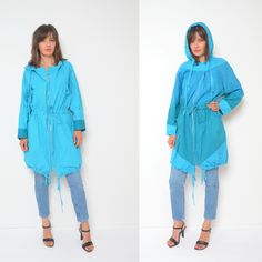 "80s hooded zipper oversized jacket. Colorful tie waist light coat. Spring summer festival wear. - Label: n/a - Era: 1980's - Color: light blue , green - Fabric: 100% cotton - Condition: very good. Ready to wear. - Tag Size: - Fits: large MEASUREMENTS: *Bust: 51.2\" (130 cm) *Waist: 44.8\" (114 cm) *Sleeve Length (from the armpit to the wrist): 16.5\" (42 cm) *Length: 36.6\" (93 cm)" Oversized Hooded Spring Windbreaker, Oversized Parka With Drawstring Hood For Spring, Oversized Hooded Windbreaker For Spring, Spring Oversized Parka With Adjustable Hood, Spring Hooded Windbreaker With Drawstring, Vintage Spring Outerwear With Drawstring Hood, Oversized Blue Hooded Windbreaker, Summer Cotton Hooded Outerwear, Oversized Blue Windbreaker For Spring