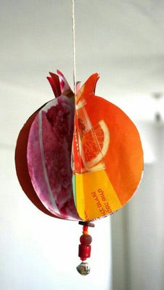 an ornament hanging from a string with fruit on it