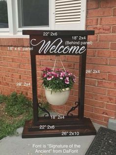 a welcome sign with flowers hanging from it's base and measurements for the planter