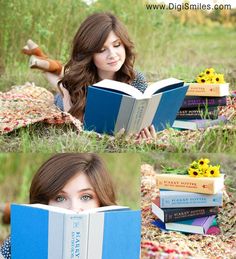 a woman laying on the grass reading a book