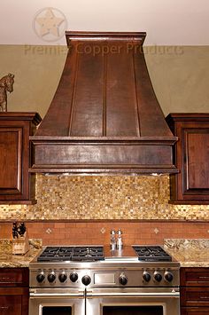 a stove top oven sitting inside of a kitchen next to wooden cabinets and counter tops