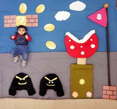 a baby laying on top of a bed next to two stuffed animals and some decorations