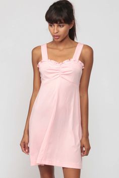 "Vintage 70s babydoll dress in baby pink with ruffled trim and an empire waist. Mini length. Every item we sell is authentic vintage and one-of-a-kind! You will receive the EXACT item shown in the photos. For reference, model is 5'7\" and measures 31-23-33. DETAILS Best fits: Extra small to Small (Note: We only have ONE in stock. If more than one size is listed it is because this item will work on a range of sizes. Check measurements for exact fit.) Condition: Very good vintage. Has a couple fai Coquette Mini Dress With Ruffle Hem, Cute Pink Mini Dress With Ruffle Hem, Pink Coquette Dress For Spring, Summer Empire Waist Mini Dress With Ruffles, Summer Mini Dress With Ruffles And Empire Waist, Daywear Coquette Ruffle Dress, Coquette Ruffle Dress For Daywear, Spring Coquette Dress With Ruffle Hem, Coquette Ruffled Day Dresses